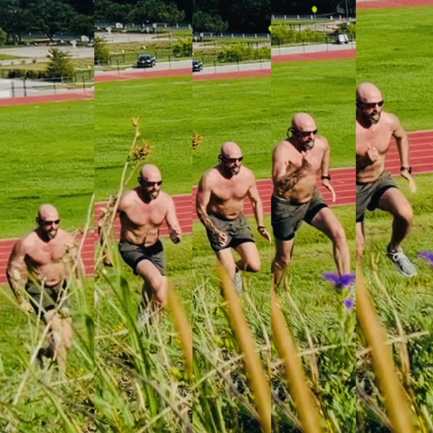 Russ sprinting up a grassy hill beside a track